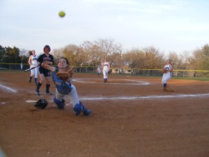 Nolan Catholic High Lady Vikings catcher Martha Thomas zeroes the apparent acceleration of a pop-up